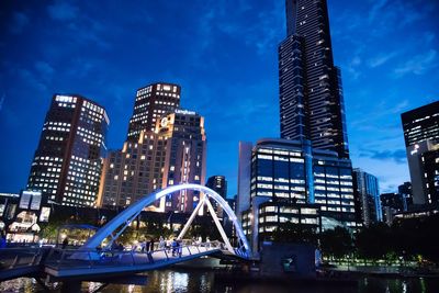 Low angle view of skyscrapers lit up at night