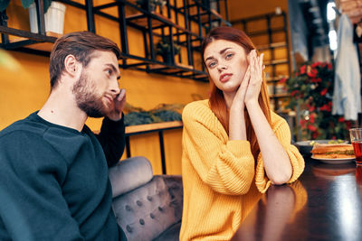 Young couple sitting on table at restaurant