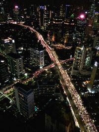 Aerial view of city lit up at night