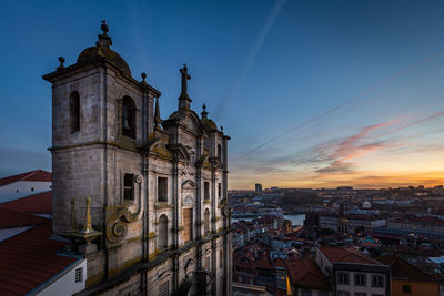 View of buildings in city at sunset