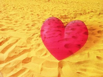 Close-up of heart shape on sand