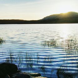 Scenic view of lake at sunset