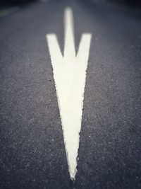 Close-up of arrow symbol on road