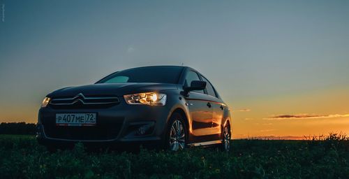 Vintage car against sky during sunset