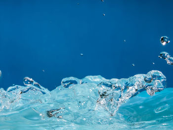 Close-up of water splashing on blue sea