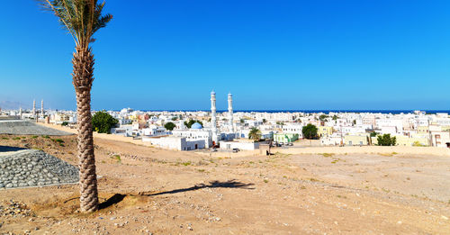 Panoramic view of buildings against blue sky