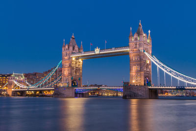 Low angle view of tower bridge against blue sky