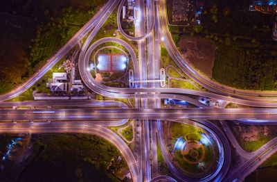 High angle view of light trails on elevated roads at night