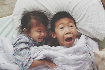High angle view of cute baby lying on bed