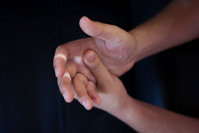 Cropped image of hands breaking fingers