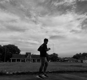 Man standing on field against sky