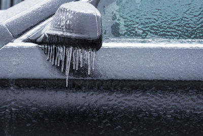 Close-up of icicles on sea shore during winter