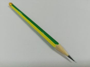 High angle view of colored pencils on white background