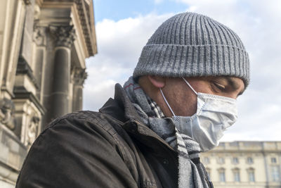 Portrait of man in city against sky