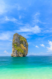 Scenic view of rock in sea against sky