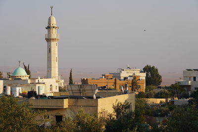 View of buildings in city against clear sky