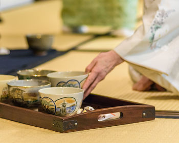 Close-up of man and coffee cup on table