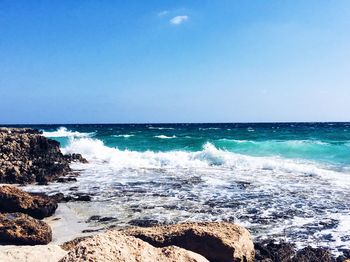 Waves splashing on rocks at beach