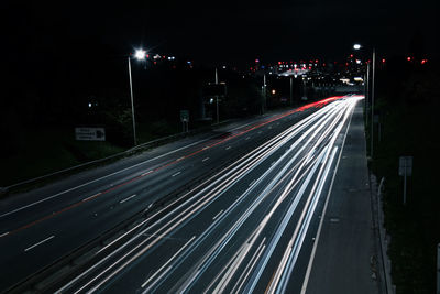 High angle view of light trails on highway at night