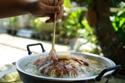 Thailand style bbq grill on a charcoal fire that is located on the bottom with pork, shrimp, squid 