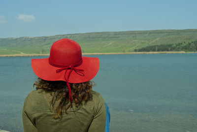 Rear view of woman in sea against sky