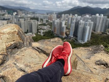 Enjoying the parnoramic view of modern skyscrapers on top of the mountain 