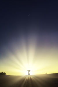 Scenic view of silhouette field against sky during sunset