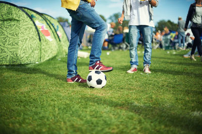 Low section of man playing soccer on field