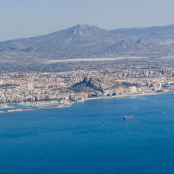 Scenic view of sea and mountains against sky