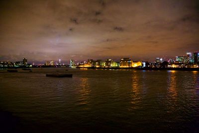 View of city at waterfront at night