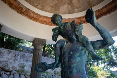 Low angle view of statue against historic building