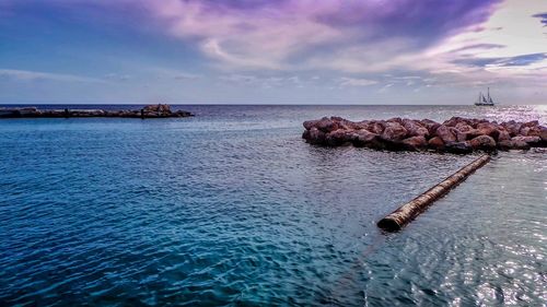 Scenic view of sea against cloudy sky