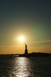 Silhouette of statue at sunset