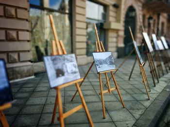 Paintings on easel at footpath for display