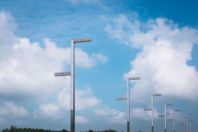 Street lights against cloudy sky