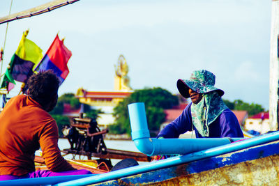 Rear view of men sitting outdoors
