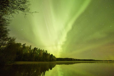 Scenic view of lake against sky at night