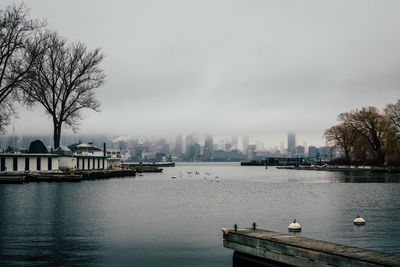 Scenic view of river and buildings against sky