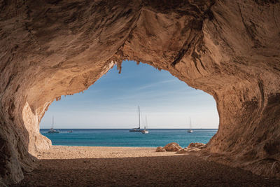 Scenic view of sea against sky seen through cave