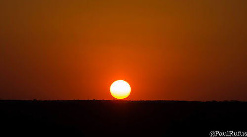 Close-up of silhouette sun against sky during sunset