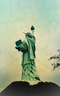 Low angle view of statue against cloudy sky