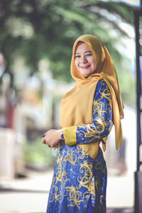 Portrait of young woman standing outdoors