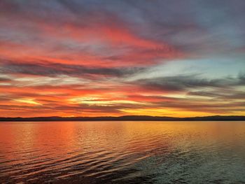 Autumn bold colors in the sky reflecting in the lake.