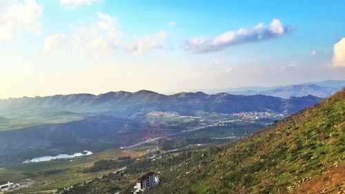 Scenic view of mountains against cloudy sky