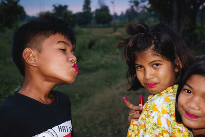 Girls and boy with lipstick