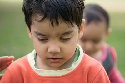 Close-up of boy looking down