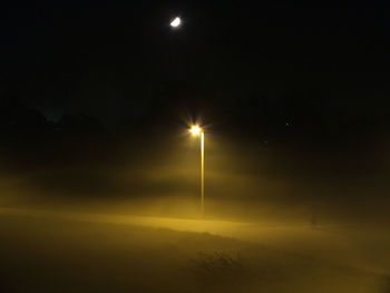 Low angle view of illuminated street light at night