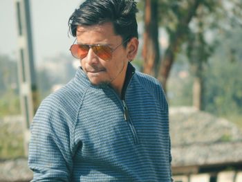 Young man wearing sunglasses standing outdoors