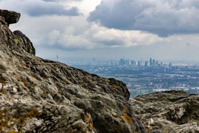 Rock formations against buildings in city