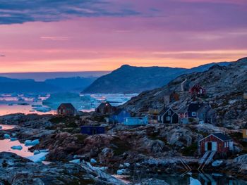 Scenic view of sea and mountains against sky